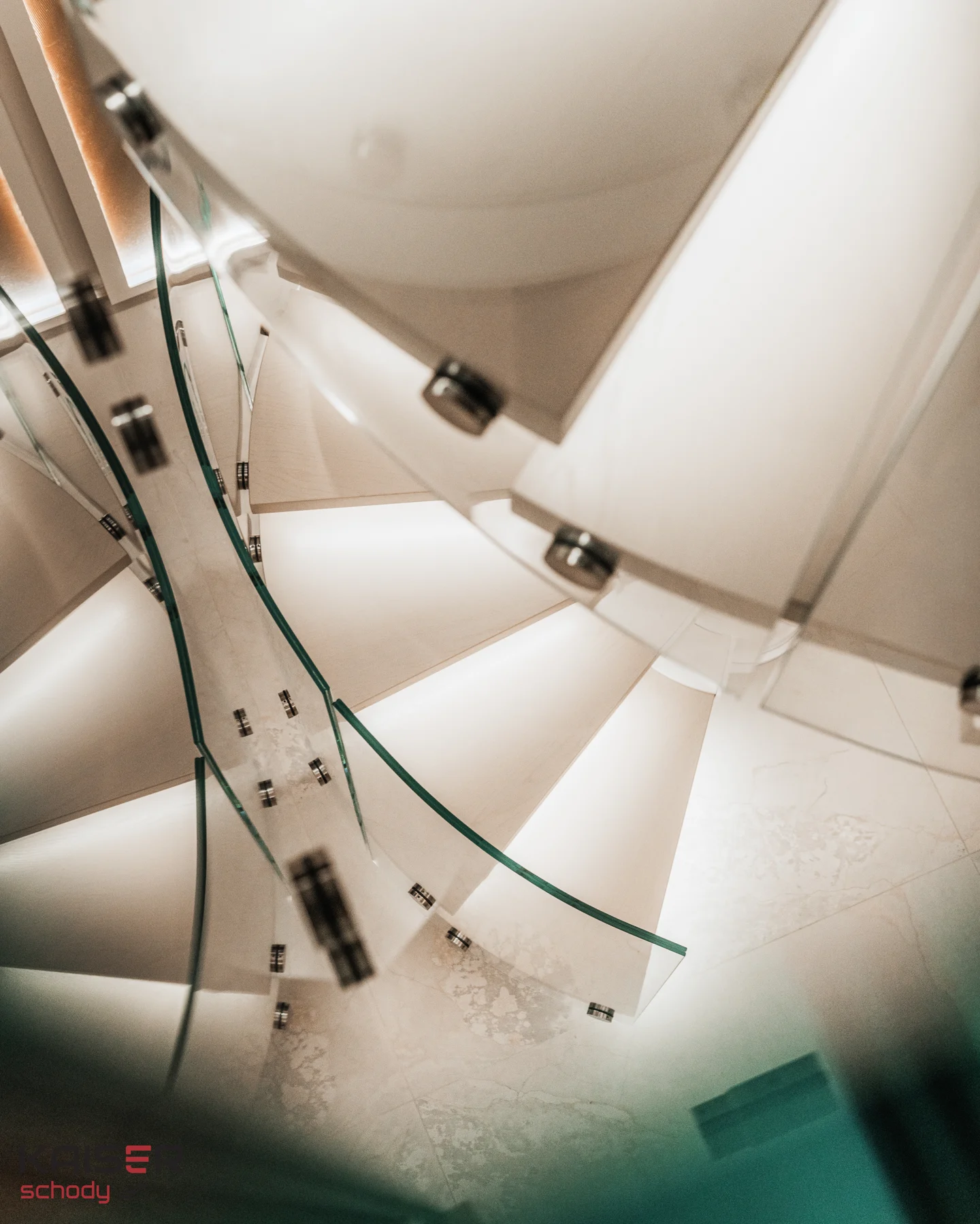 Light-coloured spiral staircase with a glass balustrade — view 09